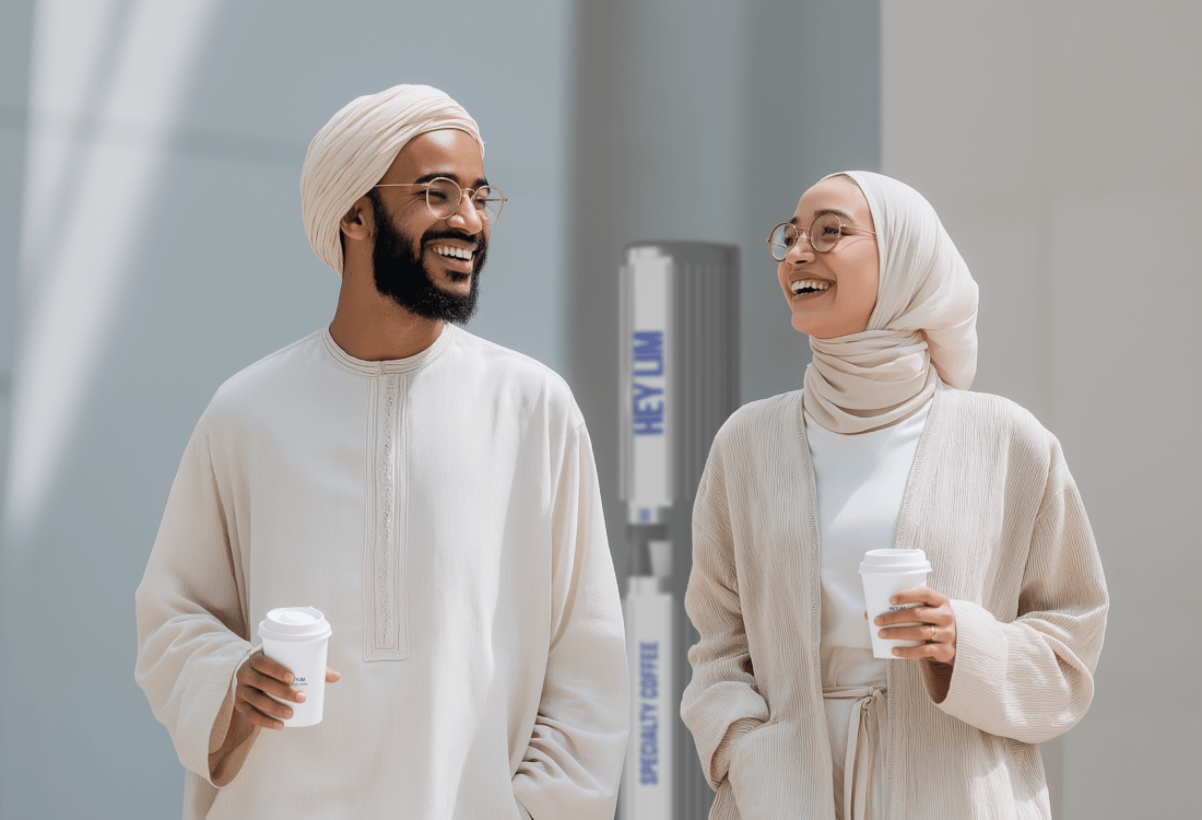 Emirati couple holding coffee cups from HEYLIM autonomous café with traditional dress and modern coffee culture